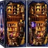Serre-livres décoratif lumineux représentant l'intérieur d'une bibliothèque de sorcier inséré entre des livres anciens sur une étagère
