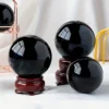 Boule d'obsidienne noire mystique naturelle 60mm, surface polie miroir.