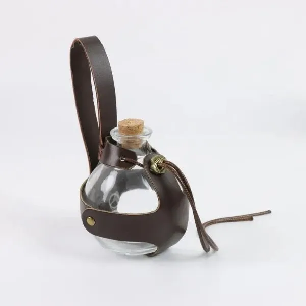 Fiole à potion magique d'herboriste en verre, harnais cuir brun, bouchon liège.
